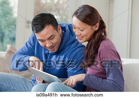 Stock Image - Couple using tablet computer together. Fotosearch
