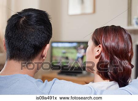 Couple watching television together View Large Photo Image Stock Photo - Couple watching television together. Fotosearch