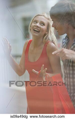 Stock Image - Couple window shopping together. Fotosearch