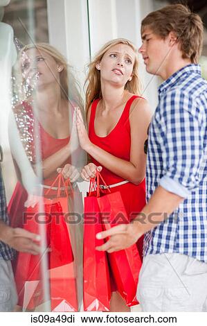 Stock Image - Couple window shopping together. Fotosearch