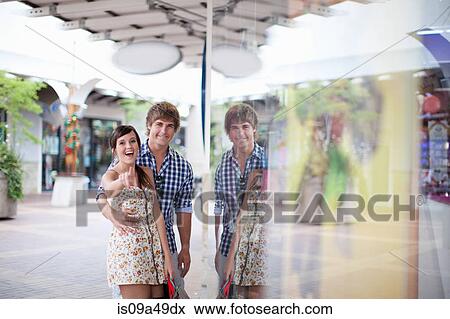 Stock Photo - Couple window shopping together. Fotosearch