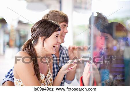 Couple window shopping together View Large Photo Image Stock Photo - Couple window shopping together. Fotosearch