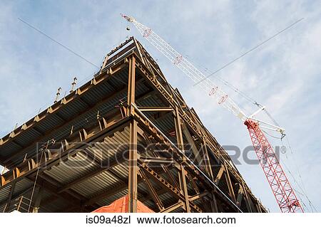 Stock Image - Crane over building under construction. Fotosearch