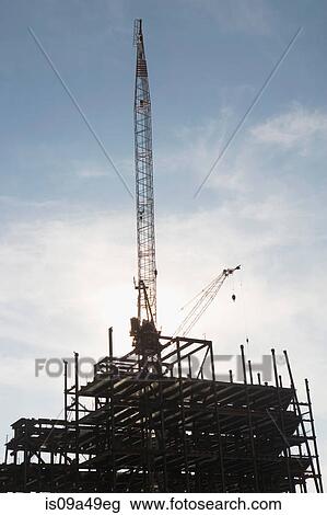 Crane over building under construction View Large Photo Image Stock Image - Crane over building under construction. Fotosearch