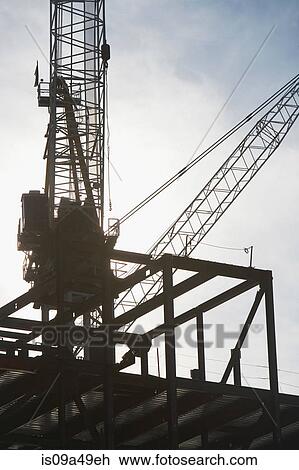 Stock Image - Crane over building under construction. Fotosearch