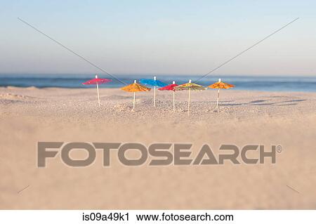 Drink umbrellas on empty beach View Large Photo Image Stock Image - Drink umbrellas on empty beach. Fotosearch
