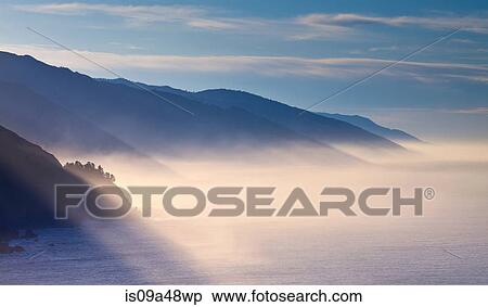 Stock Photography - Fog rolling through snowy landscape. Fotosearch