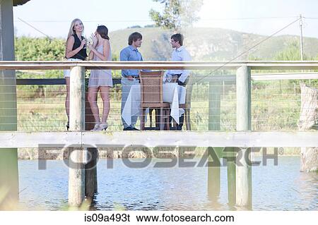 Friends on wooden deck outdoors View Large Photo Image Stock Photograph - Friends on wooden deck outdoors. Fotosearch