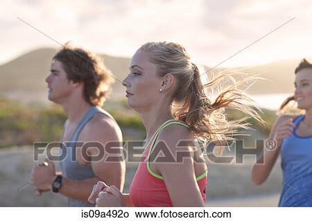 Friends running on beach View Large Photo Image Picture - Friends running on beach. Fotosearch