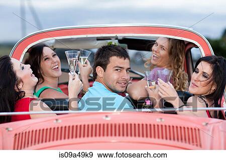 Stock Photo - Friends toasting in convertible. Fotosearch