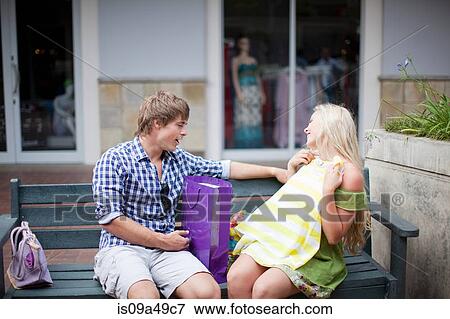 Man admiring girlfriend's shopping View Large Photo Image Stock Photo - Man admiring girlfriend's shopping. Fotosearch