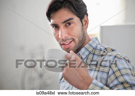 Man drinking cup of coffee in kitchen View Large Photo Image Stock Image - Man drinking cup of coffee in kitchen. Fotosearch