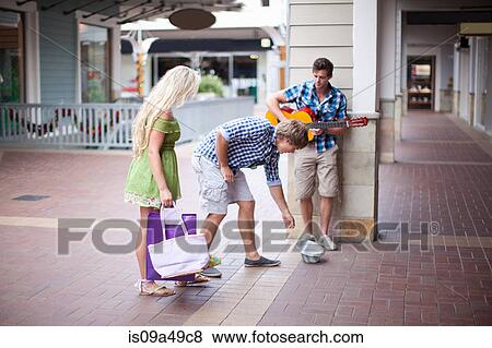 Man giving change to guitar player View Large Photo Image Stock Photo - Man giving change to guitar player. Fotosearch