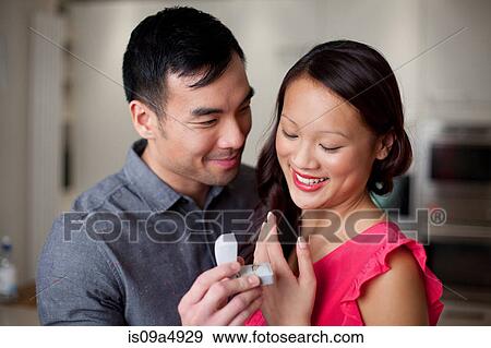 Man giving girlfriend engagement ring View Large Photo Image Stock Photo - Man giving girlfriend engagement ring. Fotosearch