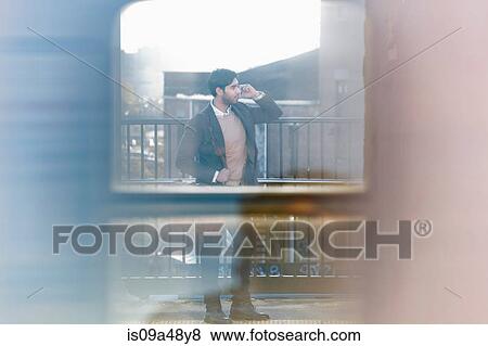 Man on cell phone at train station View Large Photo Image Stock Photo - Man on cell phone at train station. Fotosearch