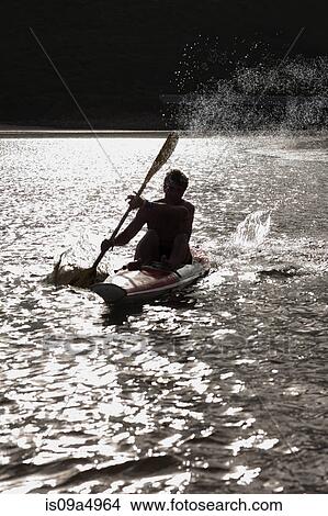 Picture - Man rowing kayak in lake. Fotosearch