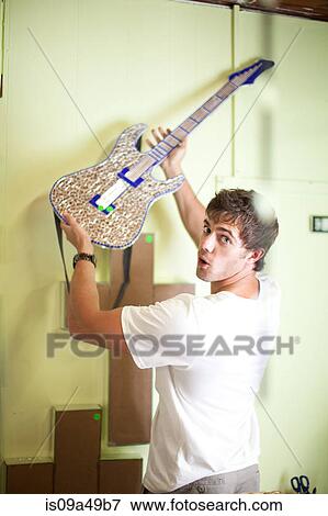 Stock Photo - Man shopping in thrift store. Fotosearch