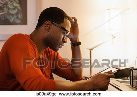 Man using tablet computer at desk View Large Photo Image Stock Image - Man using tablet computer at desk. Fotosearch