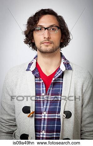 Man wearing glasses indoors View Large Photo Image Picture - Man wearing glasses indoors. Fotosearch
