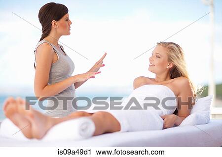 Masseuse talking to client outdoors View Large Photo Image Stock Image - Masseuse talking to client outdoors. Fotosearch