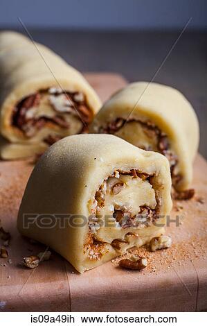 Stock Image - Nuts in dough on cutting board. Fotosearch