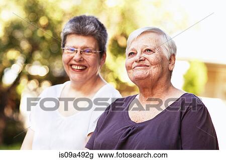 Older women smiling together outdoors View Large Photo Image Stock Image - Older women smiling together outdoors. Fotosearch
