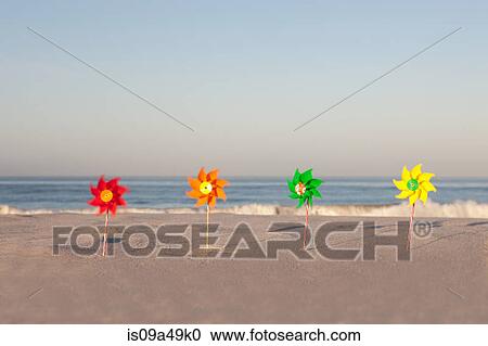Stock Image - Pinwheels on empty beach. Fotosearch