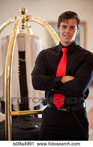Porter with luggage cart in hotel lobby View Large Photo Image Stock Image - Porter with luggage cart in hotel lobby. Fotosearch