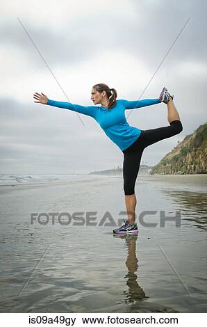 Runner practicing yoga on beach View Large Photo Image Stock Photo - Runner practicing yoga on beach. Fotosearch