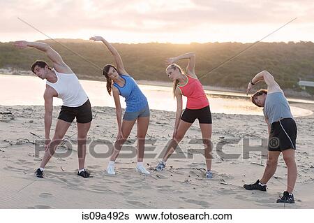 Runners stretching on beach View Large Photo Image Stock Photograph - Runners stretching on beach. Fotosearch