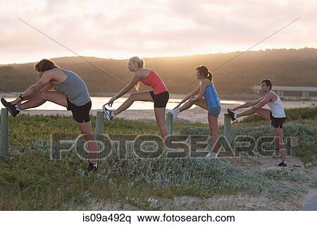 Runners stretching on beach View Large Photo Image Stock Photography - Runners stretching on beach. Fotosearch
