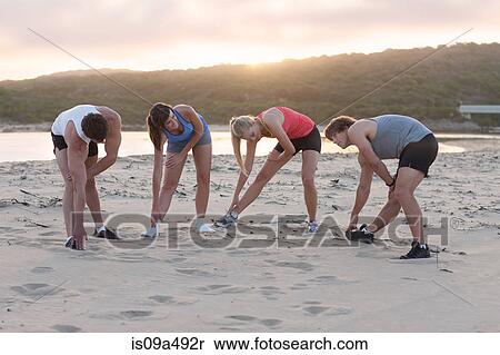 Runners stretching on beach View Large Photo Image Stock Photography - Runners stretching on beach. Fotosearch