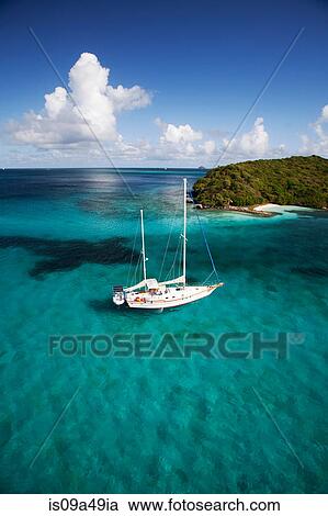 Sailboat in tropical water View Large Photo Image Stock Image - Sailboat in tropical water. Fotosearch