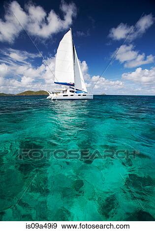 Stock Photo - Sailboat in tropical water. Fotosearch