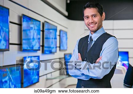 Picture - Salesman smiling in store. Fotosearch