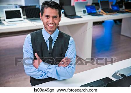 Picture - Salesman smiling in store. Fotosearch