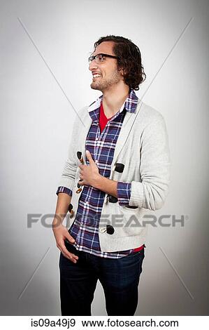 Stock Photo - Smiling man holding his stomach. Fotosearch