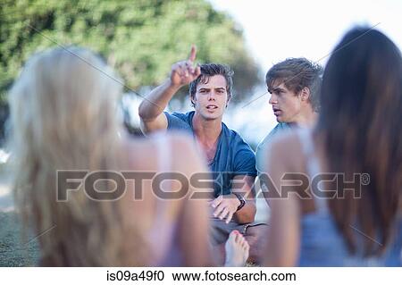 Smiling man pointing outdoors View Large Photo Image Stock Image - Smiling man pointing outdoors. Fotosearch