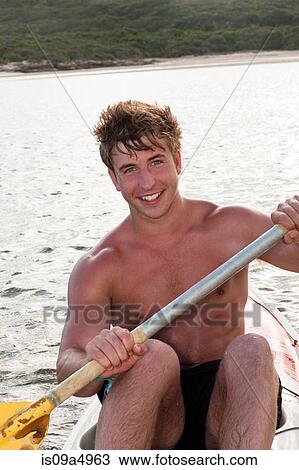 Smiling man rowing kayak in lake View Large Photo Image Stock Image - Smiling man rowing kayak in lake. Fotosearch