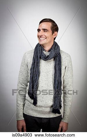 Smiling man wearing scarf indoors View Large Photo Image Stock Image - Smiling man wearing scarf indoors. Fotosearch