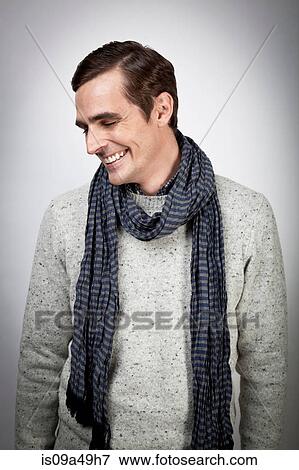 Smiling man wearing scarf indoors View Large Photo Image Stock Photo - Smiling man wearing scarf indoors. Fotosearch