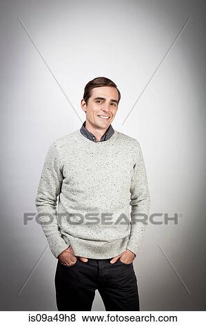 Stock Photo - Smiling man with hands in pockets. Fotosearch
