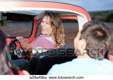 Smiling woman driving convertible View Large Photo Image Stock Image - Smiling woman driving convertible. Fotosearch