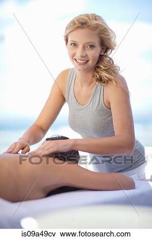 Smiling woman giving massage outdoors View Large Photo Image Stock Photo - Smiling woman giving massage outdoors. Fotosearch