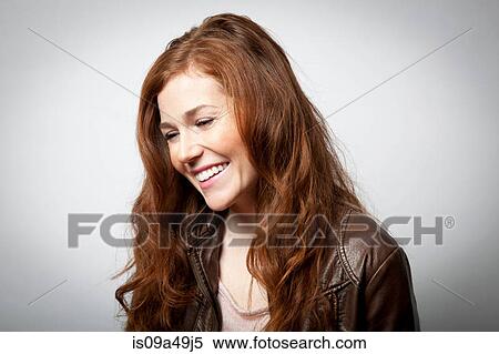 Stock Photography - Smiling woman laughing indoors. Fotosearch