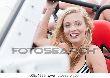 Smiling woman riding in jeep View Large Photo Image Stock Photo - Smiling woman riding in jeep. Fotosearch