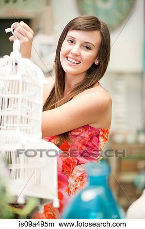 Picture - Smiling woman shopping in store. Fotosearch