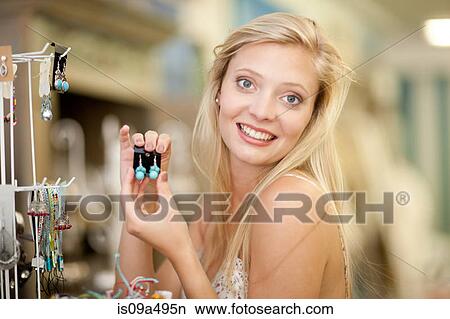 Picture - Smiling woman shopping in store. Fotosearch