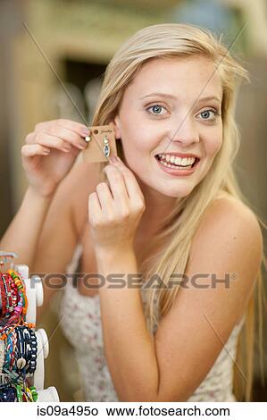 Smiling woman shopping in store View Large Photo Image Picture - Smiling woman shopping in store. Fotosearch