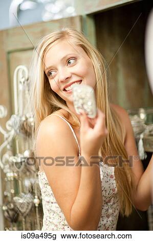 Stock Image - Smiling woman shopping in store. Fotosearch